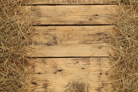 Dried hay on wooden background, flat lay. Space for textの写真素材