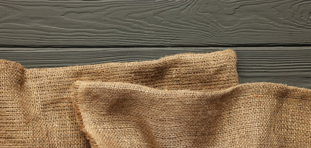 Burlap fabric on gray wooden table, top viewの写真素材