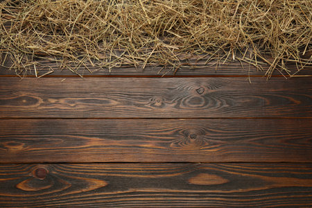 Dried hay on wooden background, flat lay. Space for text