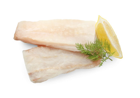 Fresh raw cod fillets with dill and lemon isolated on white, top view