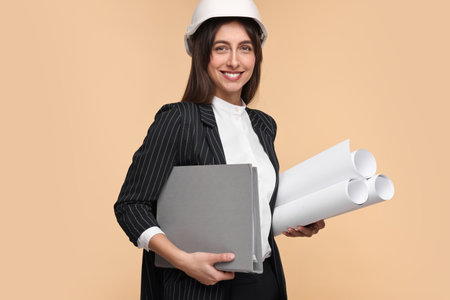 Architect in hard hat with drafts and folder on beige background