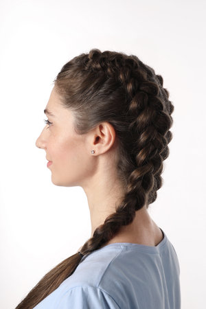 Woman with braided hair on light background