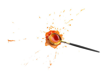 Spoon with tasty ketchup isolated on white, top view. Tomato sauceの写真素材