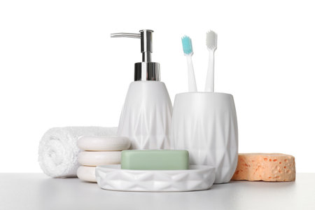 Bath accessories. Different personal care products on table against white backgroundの写真素材