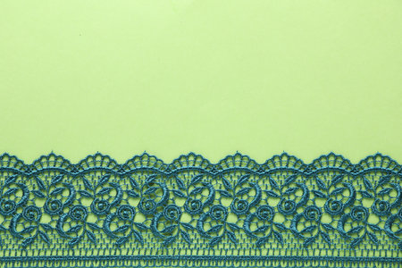 Beautiful lace on green background, top view. Space for textの写真素材