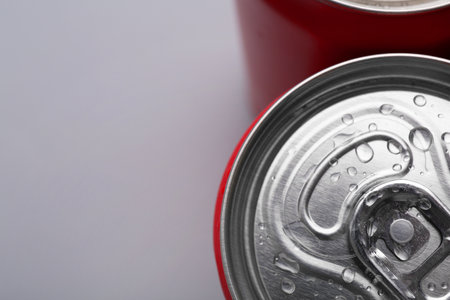 Energy drinks in wet cans on gray background, top view. Space for textの写真素材