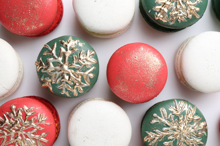 Beautifully decorated Christmas macarons on white background, top viewの写真素材