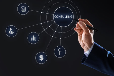 Consulting Businessman using digital screen with icons on dark background, closeupの写真素材