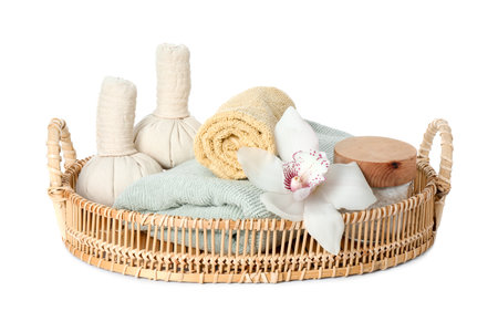 Spa composition. Towels, herbal massage bags, sea salt and beautiful flower on white backgroundの写真素材