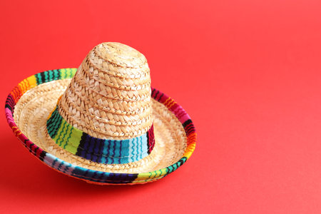 One Mexican sombrero hat on red background. Space for textの写真素材