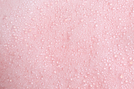 White fluffy foam on pink background, top viewの写真素材