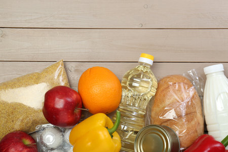 Different donation food on wooden table, flat lay. Space for textの写真素材