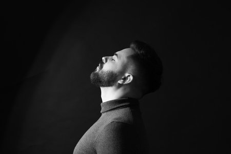 Portrait of handsome bearded man on dark background. Black and white effectの写真素材