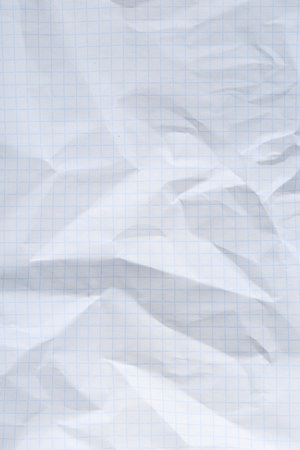 Crumpled checkered notebook sheet as background, top viewの写真素材