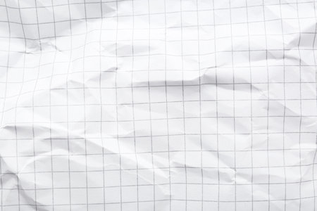 Crumpled checkered notebook sheet as background, top viewの写真素材