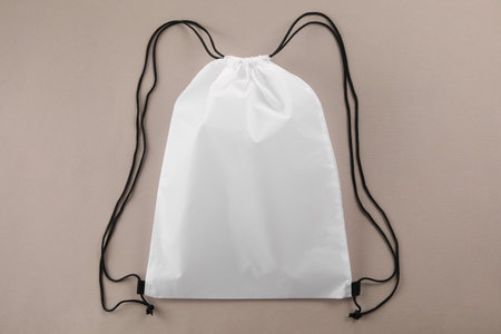 One white drawstring bag on beige background, top viewの写真素材