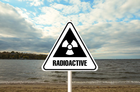 Radioactive pollution. Warning sign with hazard symbol near sea sideの写真素材