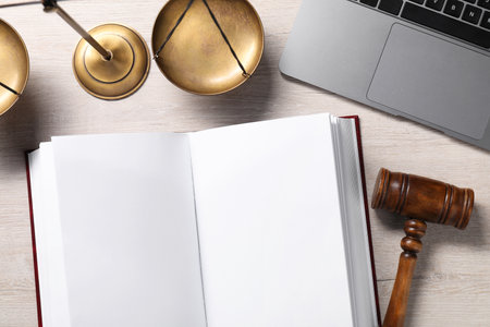 Law. Open book, gavel, laptop and scales on wooden table, flat layの写真素材