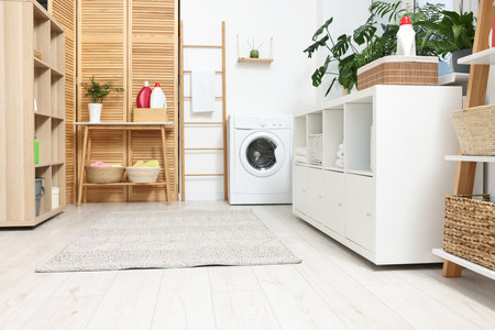 Laundry room interior with washing machine and furnitureの写真素材