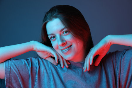 Portrait of beautiful young woman on color background