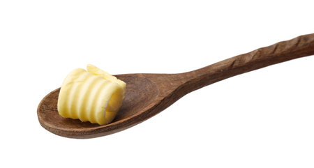 Tasty butter curl in spoon isolated on whiteの写真素材