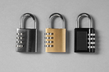Steel combination padlocks on gray background, top viewの写真素材