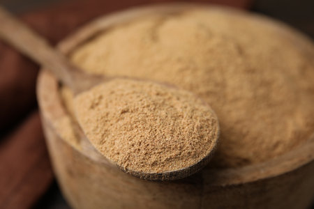 Dietary fiber. Psyllium husk powder in bowl and spoon on table, closeupの写真素材