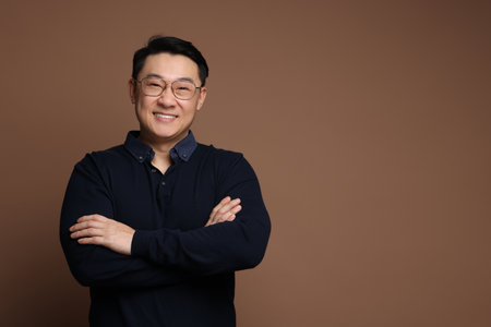 Portrait of happy man on brown background. Space for textの写真素材