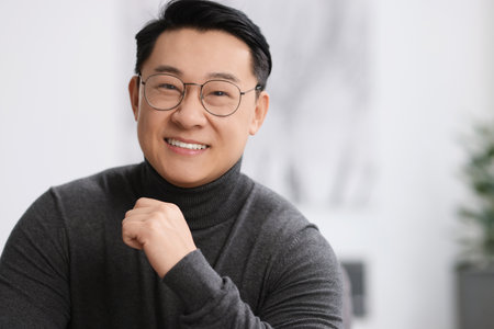 Portrait of smiling businessman on blurred background. Space for text