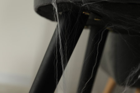 Old cobweb on chair in room, closeupの写真素材