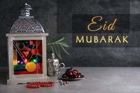 Eid Mubarak greeting card. Composition with Arabic lantern and misbaha on gray tableの写真素材