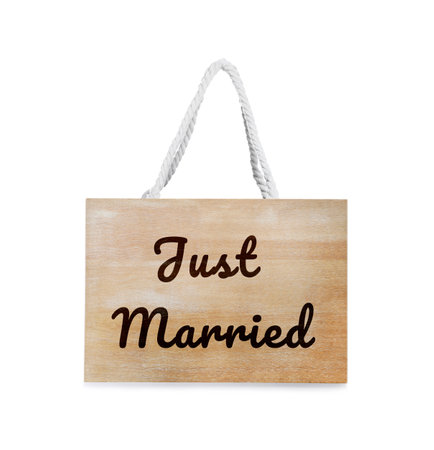 Honeymoon. Wooden board with words Just Married on white backgroundの写真素材