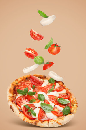 Caprese pizza and ingredients in air on dark beige backgroundの写真素材
