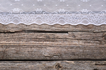 White lace on wooden table, top view. Space for textの写真素材