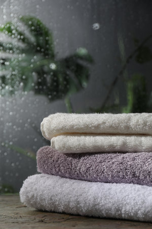 Stacked terry towels on table in bathroomの写真素材