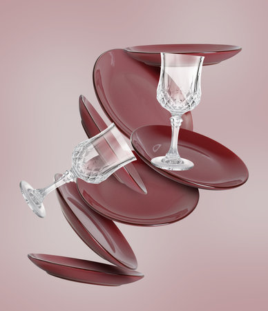 Clean plates and glasses falling on color backgroundの写真素材