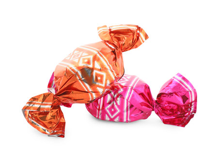 Sweet candies in colorful wrappers on white backgroundの写真素材