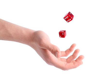 Man throwing red dice on white background, closeupの写真素材