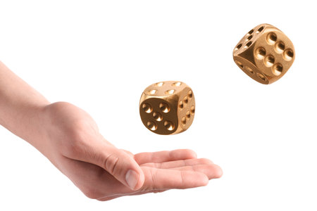 Man golden throwing dice on white background, closeupの写真素材