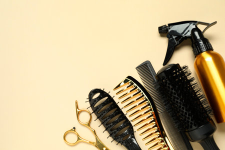 Hairdressing tools on beige background, flat lay. Space for textの写真素材