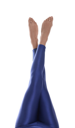 Woman with beautiful long legs wearing blue leggings on white background, closeup