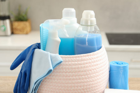 Different cleaning supplies in basket on table, closeupの写真素材