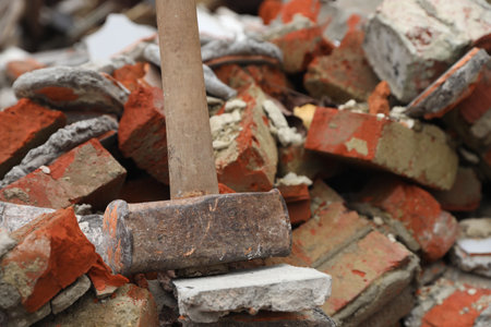 Sledgehammer on pile of broken bricks, closeupの写真素材