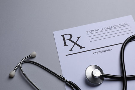 Medical prescription form and stethoscope on light gray background. Space for textの写真素材