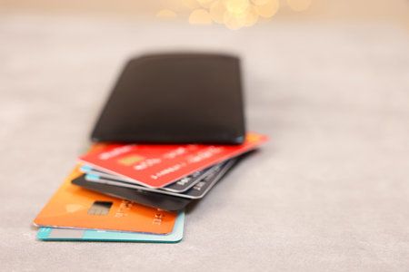 Pile of different credit cards on gray table, closeup. Space for textの写真素材