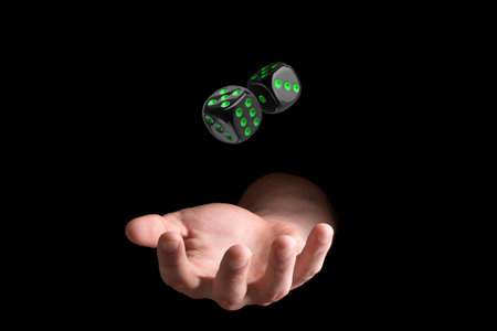 Man throwing dice on black background, closeupの写真素材