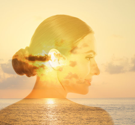 Double exposure of beautiful woman and sea at sunsetの写真素材