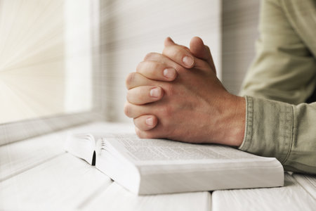 Religion. Christian man praying over Bible at table, closeupの写真素材