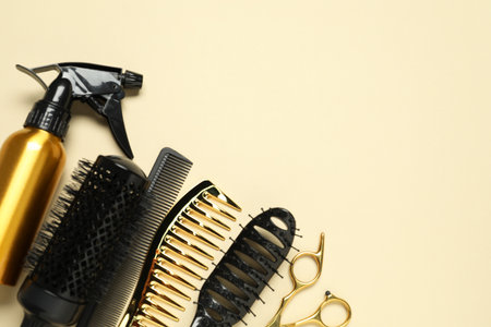 Hairdressing tools on beige background, flat lay. Space for textの写真素材