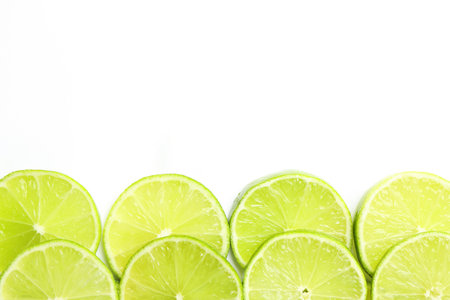 Fresh juicy lime slices on white background, flat lay. Space for textの写真素材